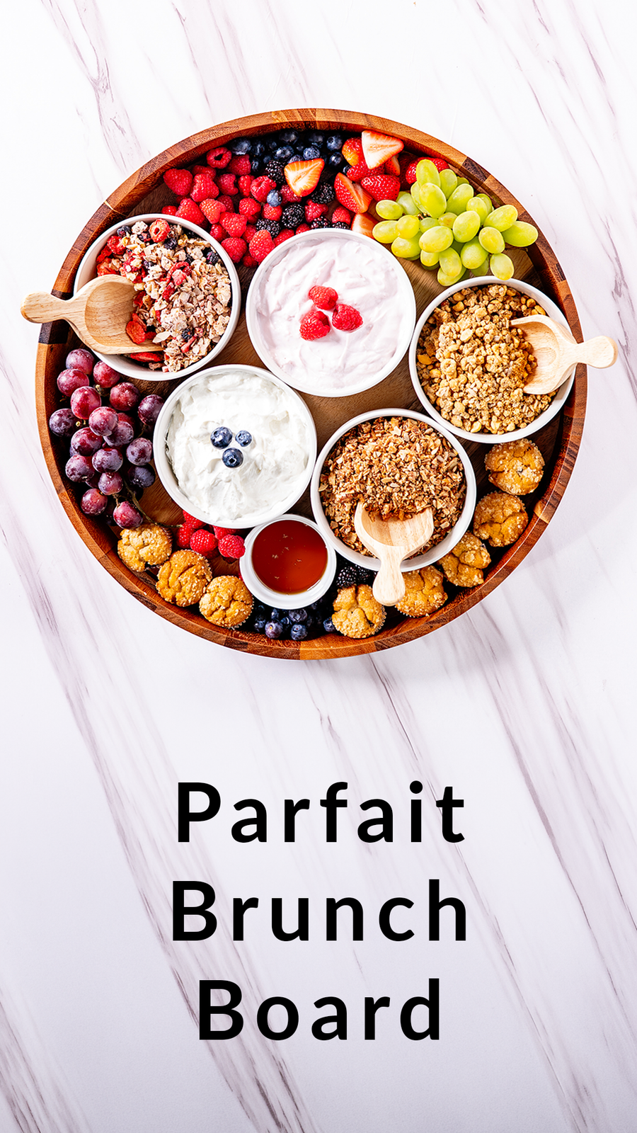 Parfait Brunch Board with various fruits, yogurt, and granola on a white background